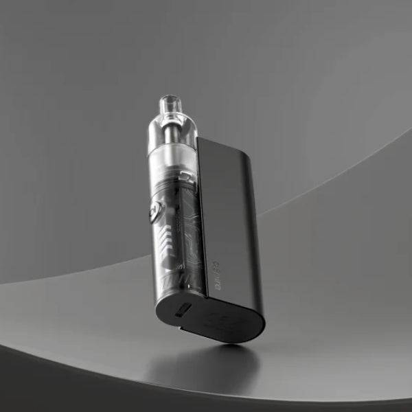 Sleek black vaping device with transparent tank standing on curved gray surface