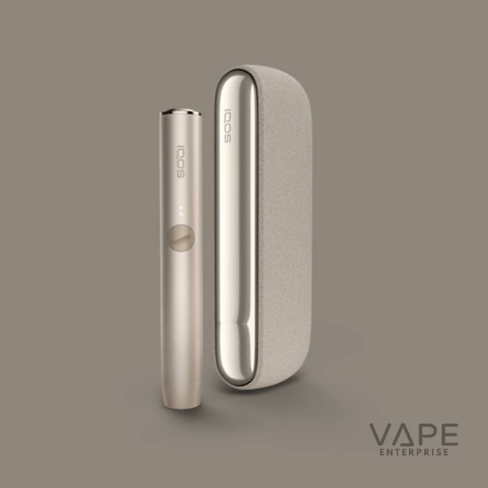 IQOS ILUMA Pebble Beige electronic cigarette starter kit with sleek charging case on beige background
