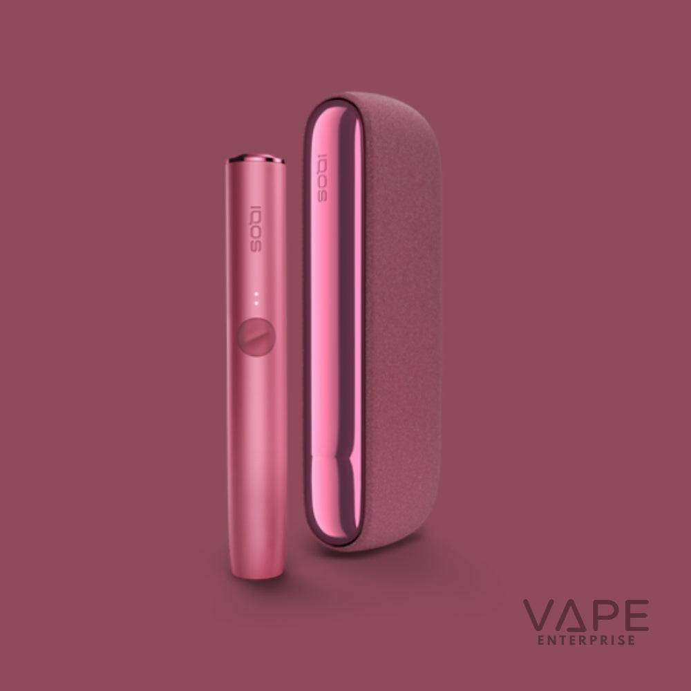 Sunset Red IQOS ILUMA Starter Kit with sleek vape device and charging case on maroon background