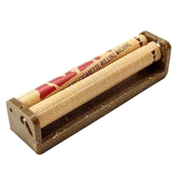 Vintage plastic cigarette rolling machine with beige patterned rollers and red text