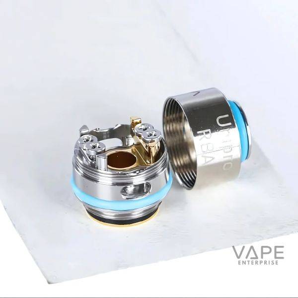 OXVA Unipro RBA coil components with silver finish and blue rubber rings on white surface